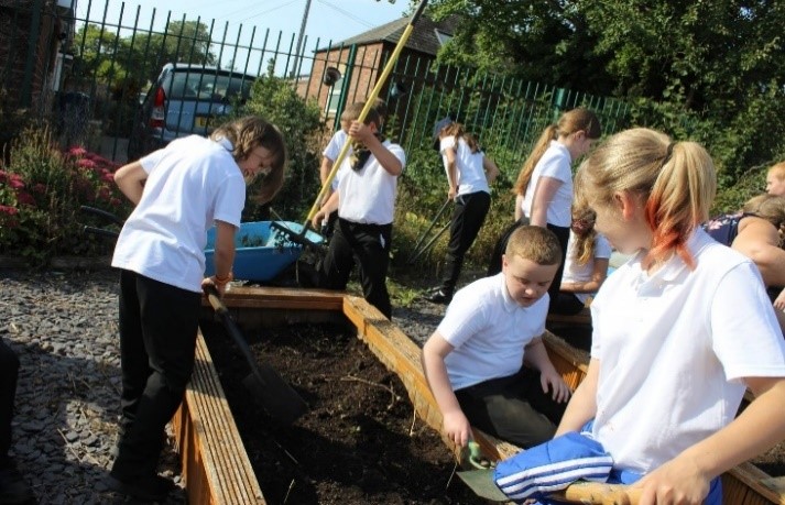 Pupils working on a community garden area