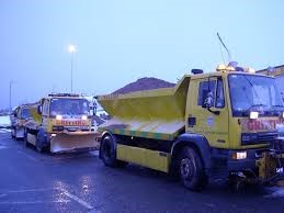 A troop of refuse collection vans on a road