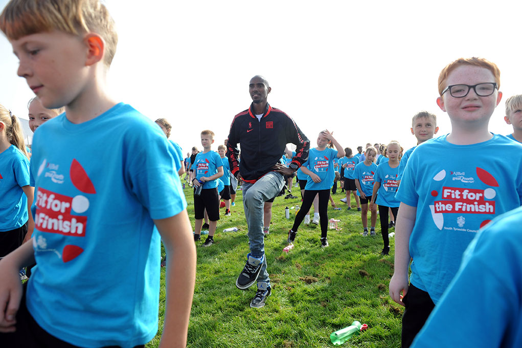 Young people warming up for the ‘Fit for the Finish’ fun run with Olympic athlete Mo Farrah