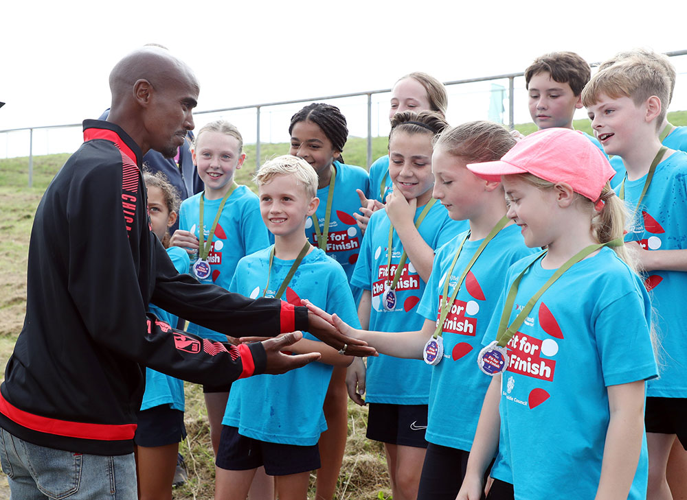 Olympic gold medalist Mo Farrah meets children and young people taking part in the ‘Fit for the Finish’ fun run