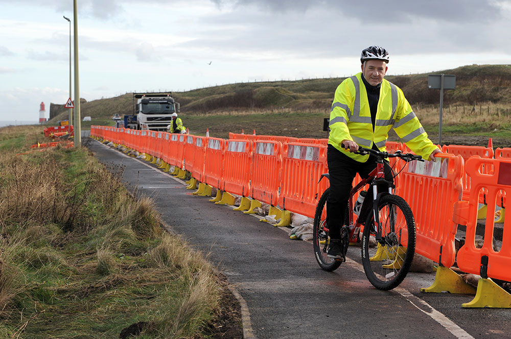 Cllr Gibson cycling at the newly-realigned coastal route following £2m investment in cycling and pedestrian network improvements this year