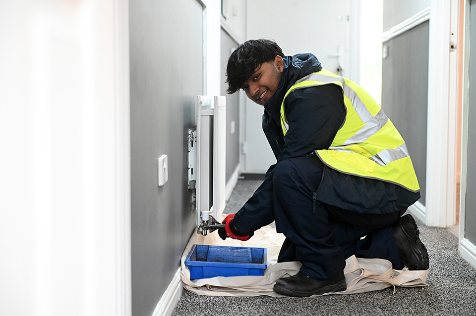 Person making repairs to a radiator