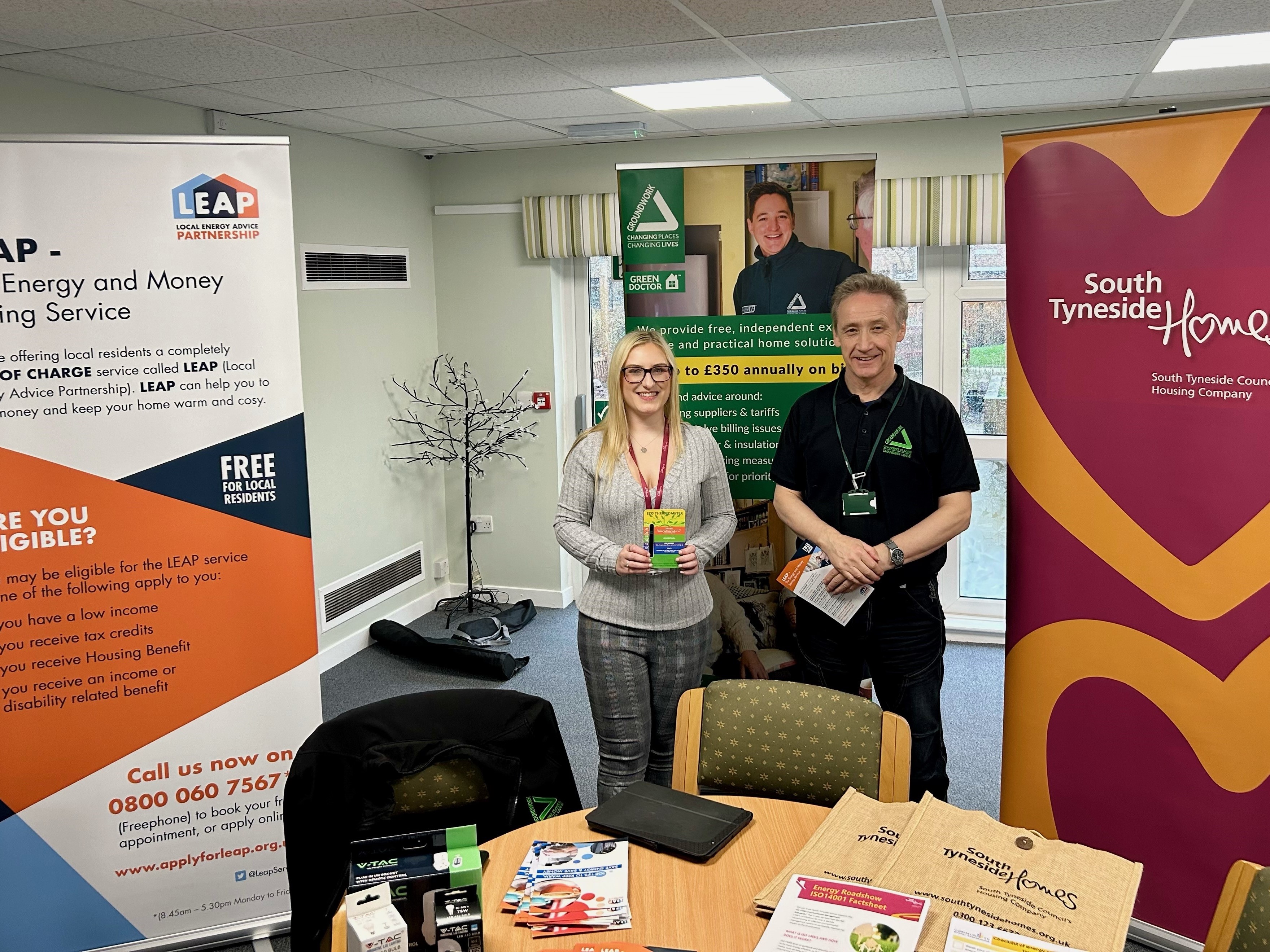 Two people stood at a South Tyneside Housing Services booth at the Energy Roadshow event at Blenkinsop Court