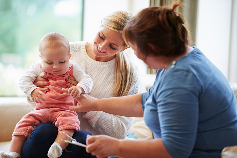 A woman holding a baby.