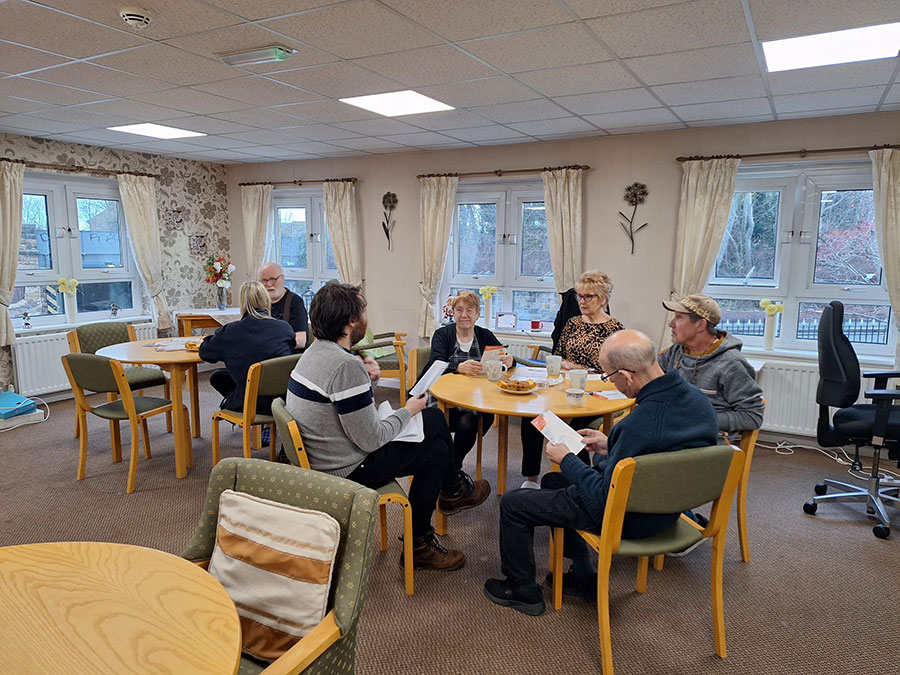 Residents sat at tables reading advice leaflets.