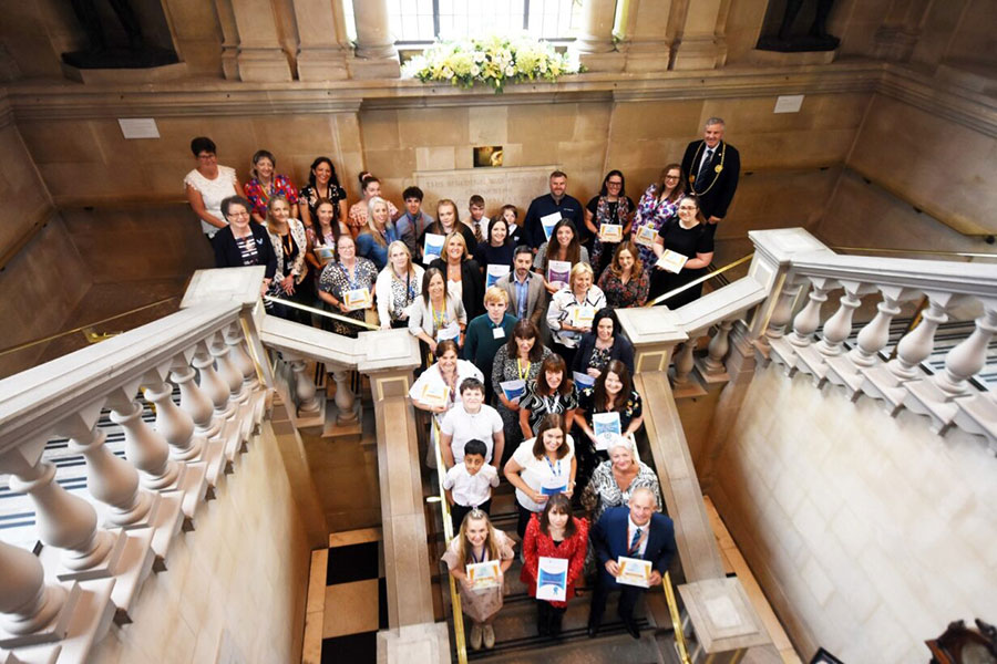 Participants of the Healthy Schools celebration stood on the Town Hall staircase.