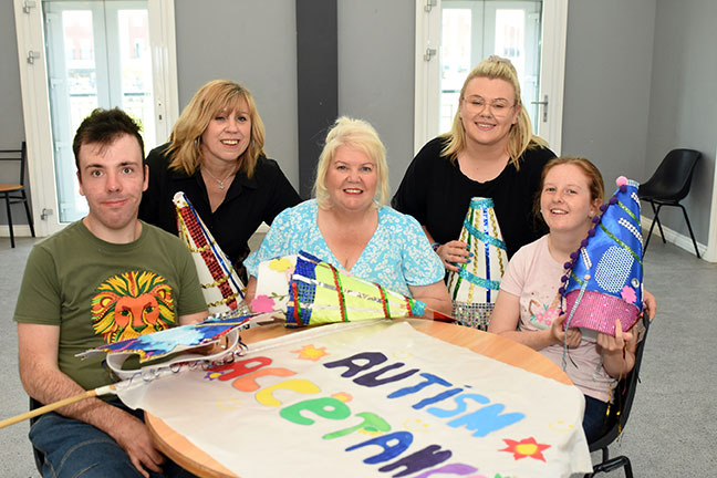 Cllr Audrey Huntley and members of Autism Able preparing parade signs